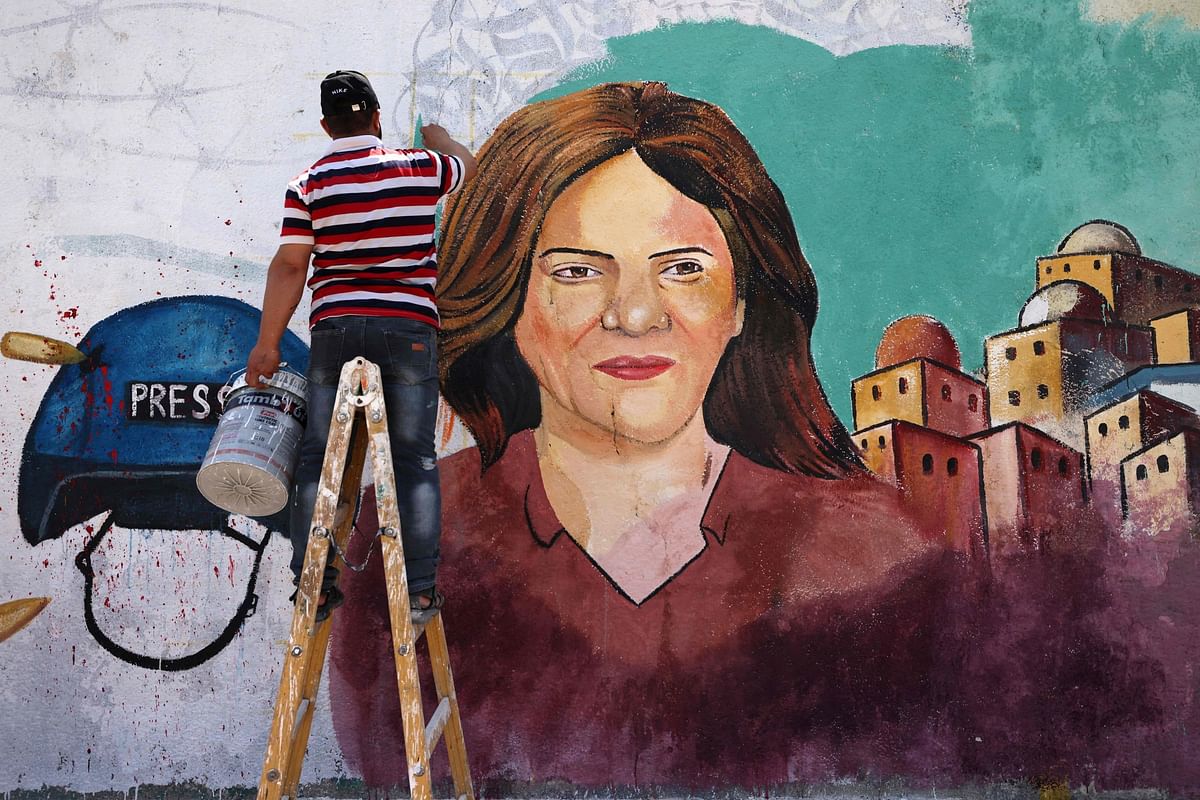 Palestinian artists paint a mural in honour of slain veteran Al-Jazeera journalist Shireen Abu Akleh in Gaza City. Credit: AFP Photo