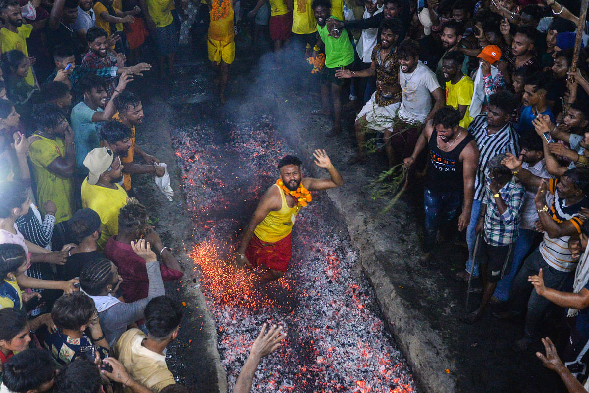 A Hindu devotee runs on burning coal during the Maa Maariamma Mela festival, in Jalandhar. Credit: PTI Photo