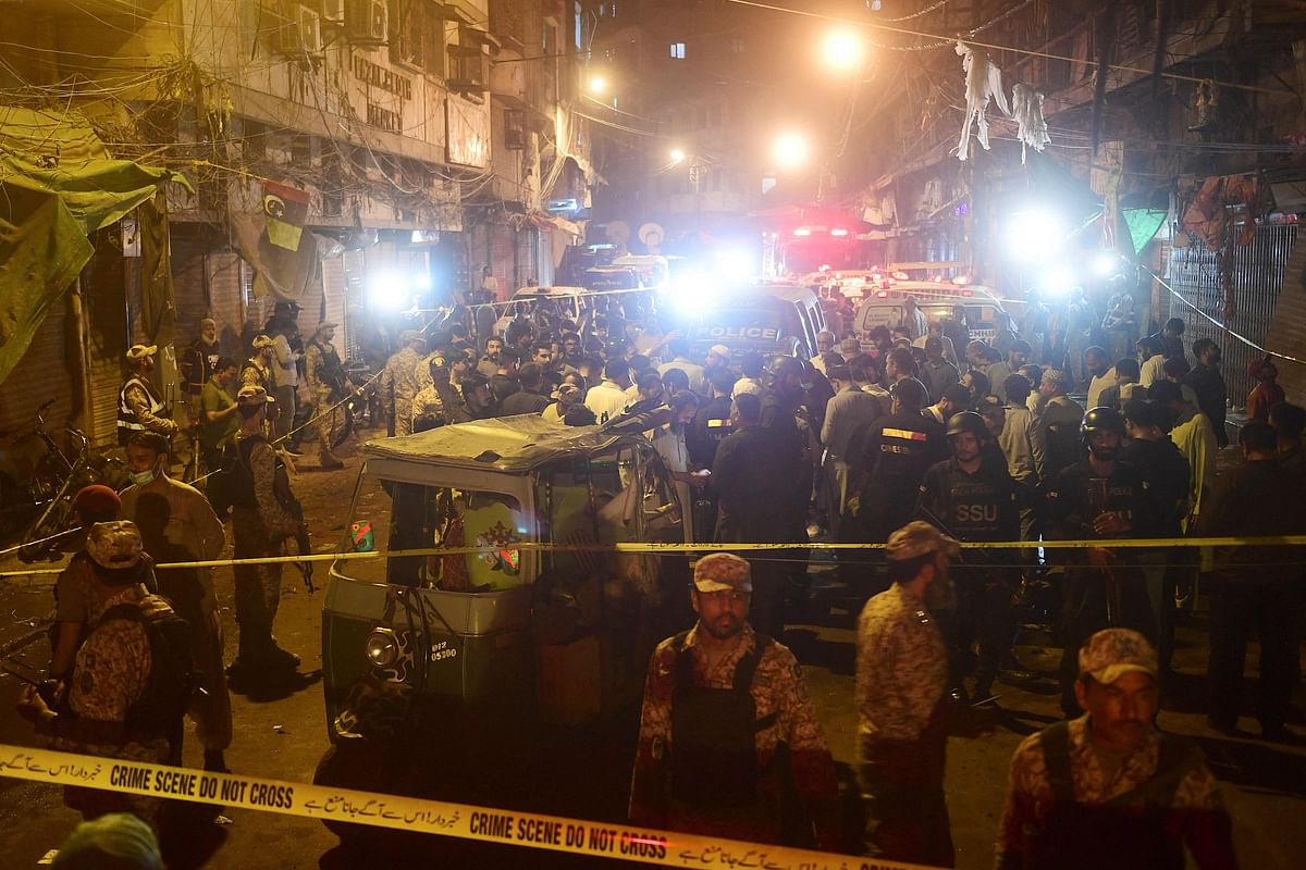Security officials inspect the site after a bomb blast in Karachi. Credit: AFP Photo