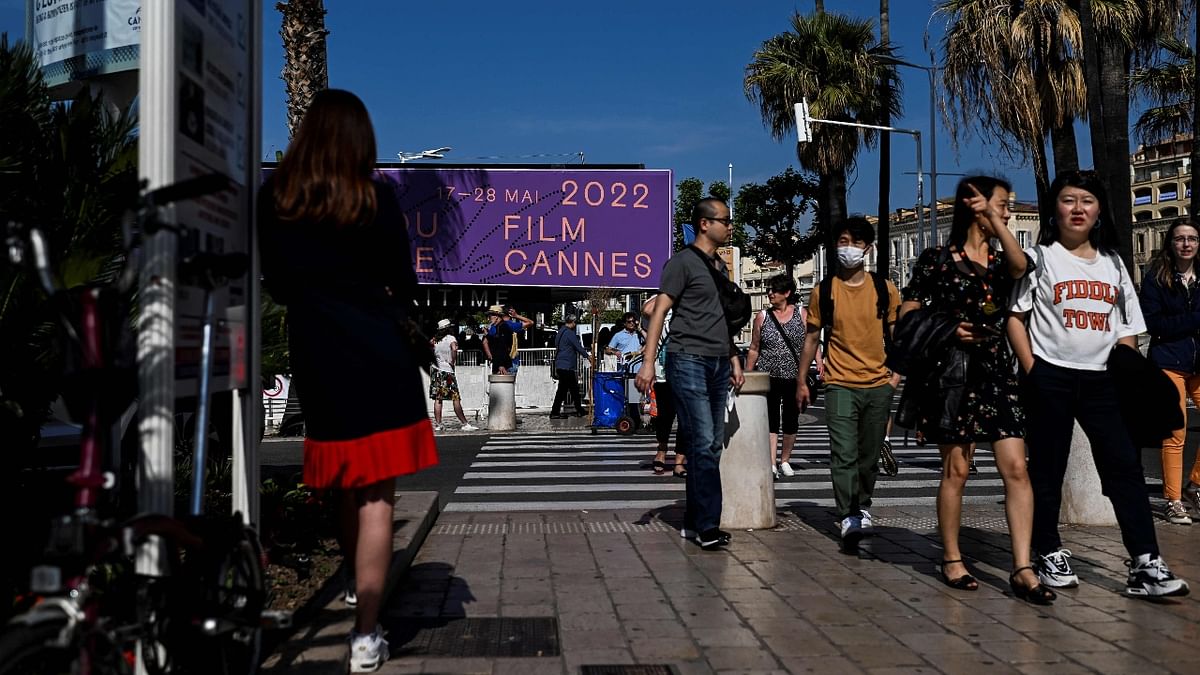 People walk in front of Palais des Festivals in Cannes, France. Credit: AFP Photo