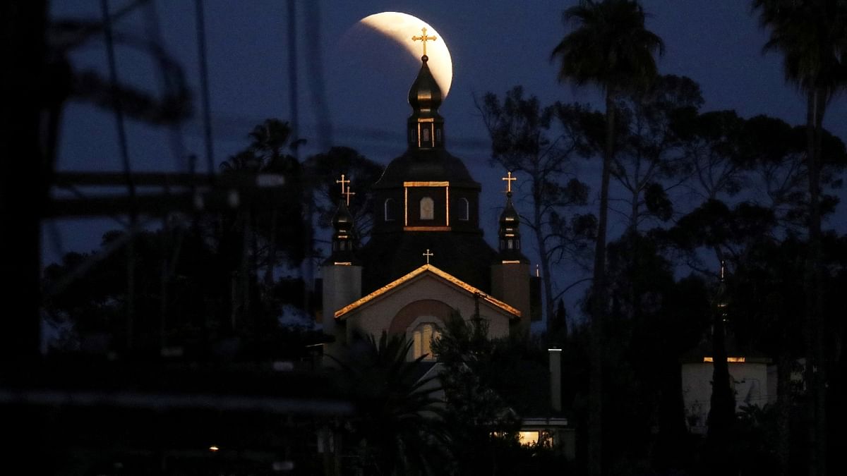 The St. Andrew's Ukrainian Orthodox Church is seen as the moon moves through the shadow of the earth during a
