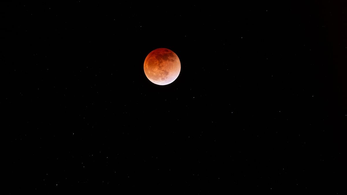 The blood moon is seen during a total lunar eclipse in Canta, east of Lima. Credit: AFP Photo