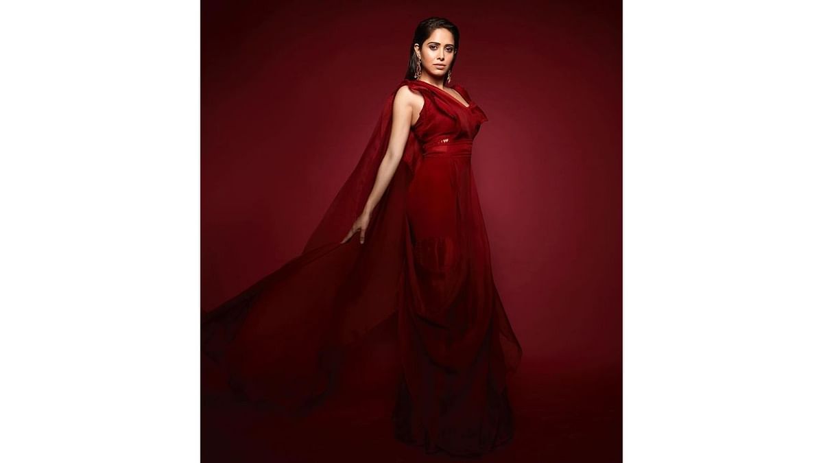 Nushrratt raises the temperature as she poses in a red floor-length gown. Credit: Instagram/nushrrattbharuccha