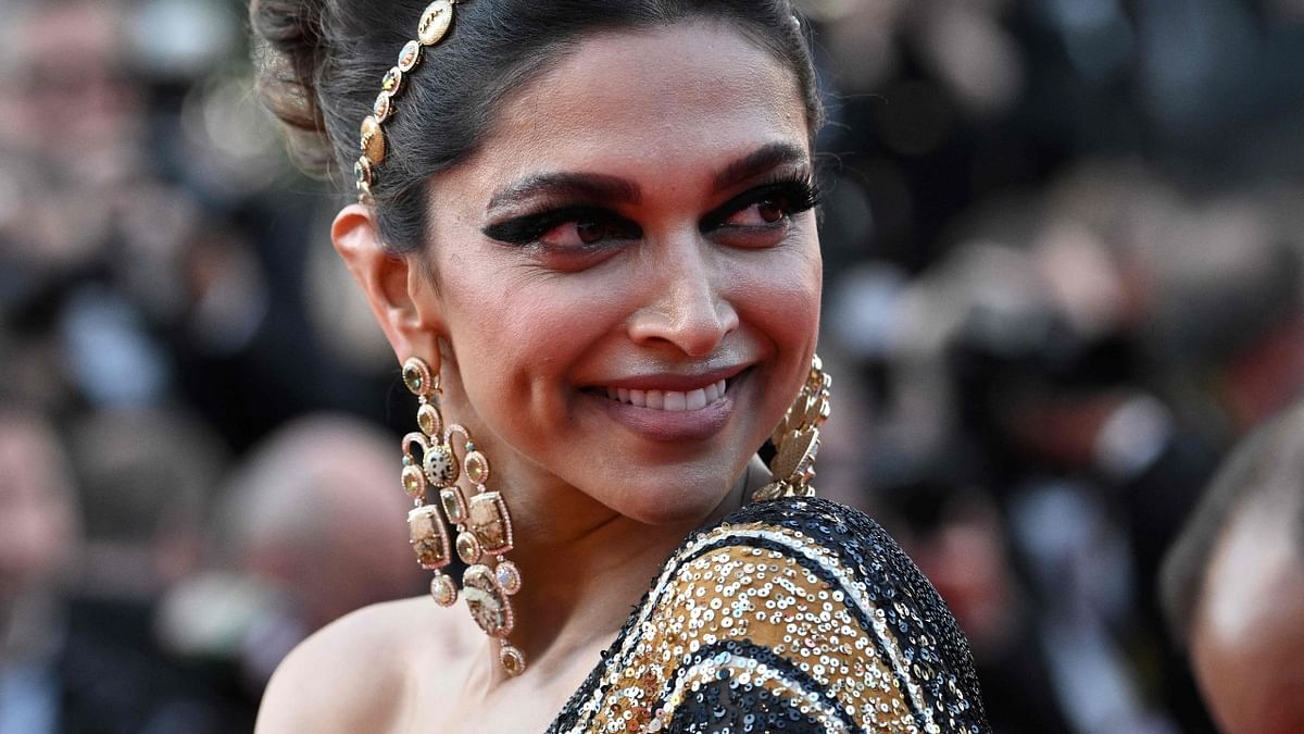 Actor Deepika Padukone gets clicked as she walks the red carpet. Credit: AFP Photo