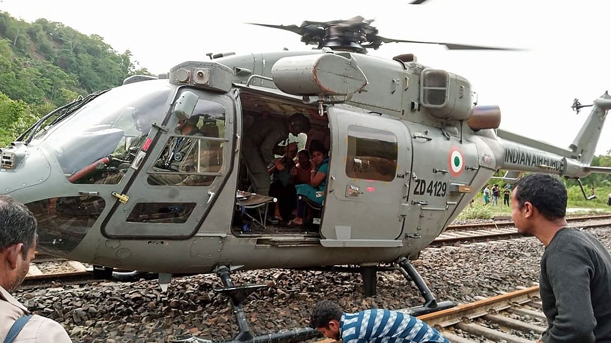 Indian Air Force personnel evacuate passengers stranded at Ditokchera railway station after floods due to heavy rain, in Dima Hasao, Assam. Credit: PTI Photo