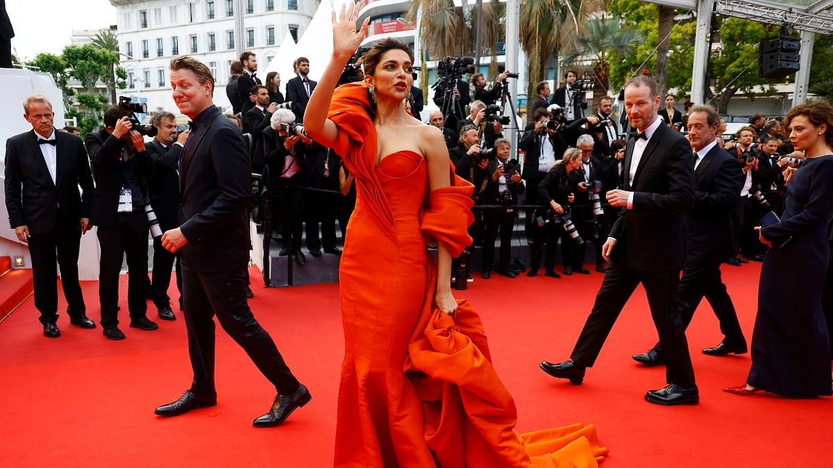 Bollywood diva Deepika Padukone sparkled in an orange frill gown on Day 7 of the 75th Annual Cannes Film Festival as she wowed everyone with her red carpet look at the screening of the film 'L'innocent.' Credit: Reuters Photo