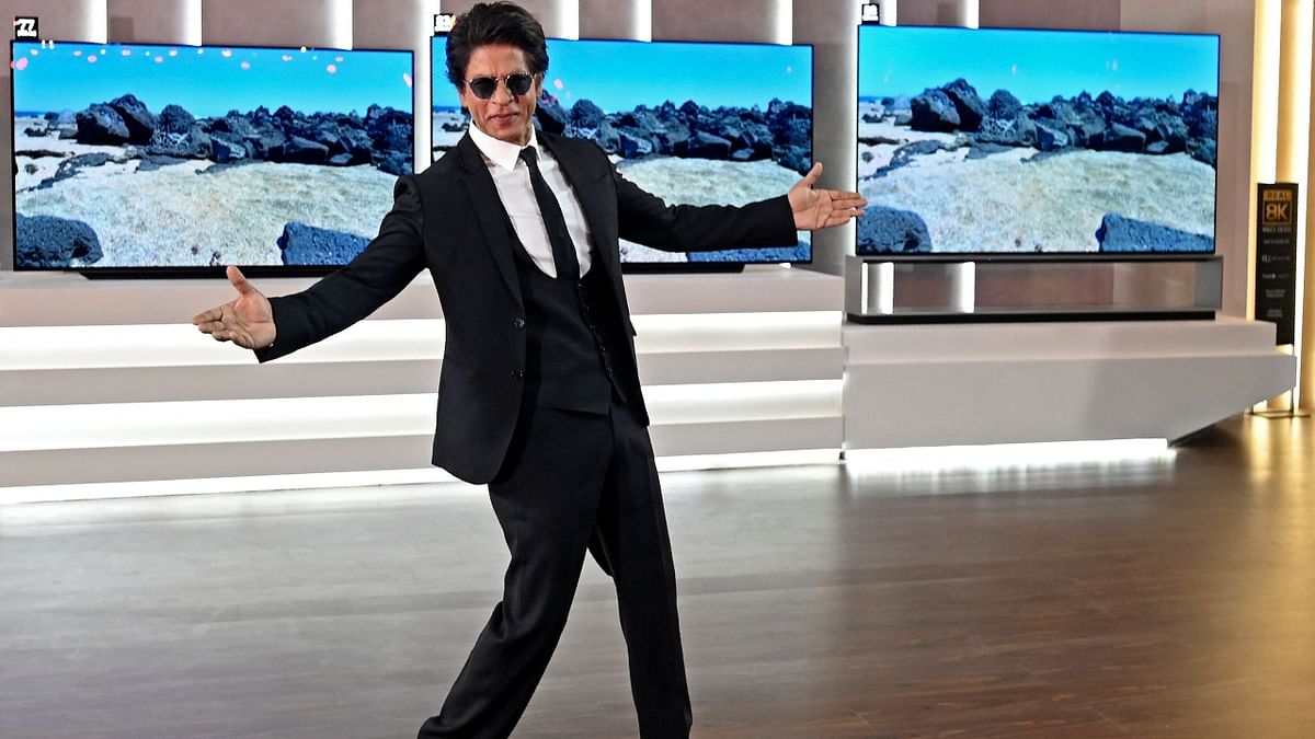 SRK also won audiences’ hearts with his signature pose while interacting with the media at the event. Credit: AFP Photo