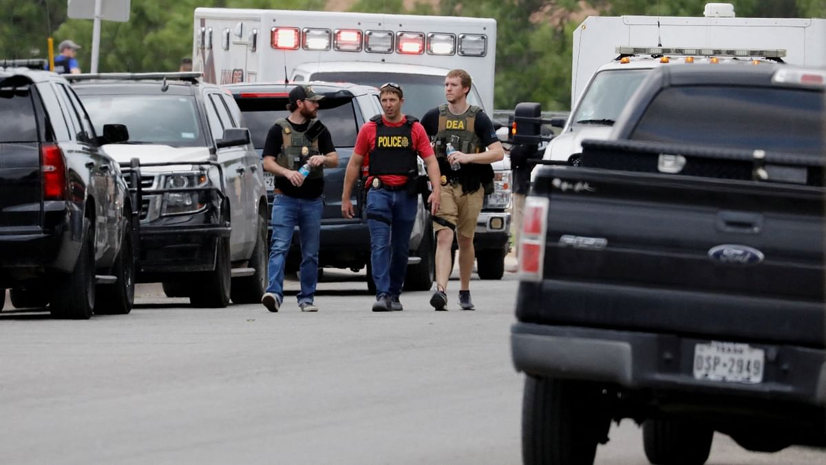 Across the street from the school, state troopers were scattered across the school lawn and an ambulance idled with its lights flashing. Credit: Reuters Photo