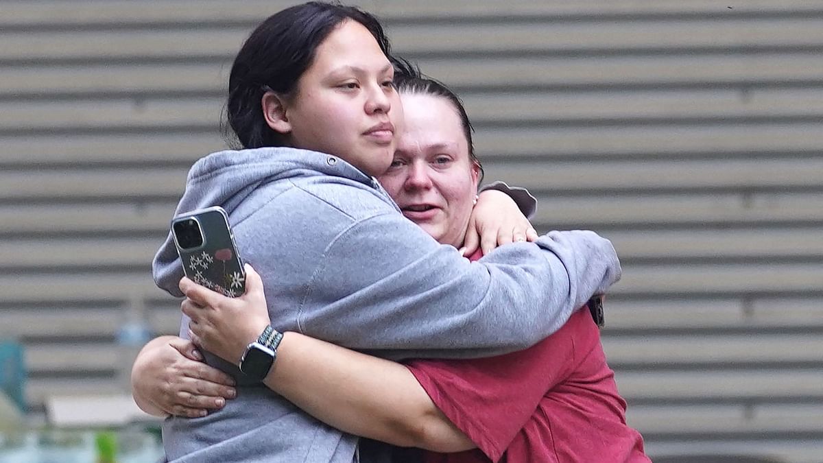 Two women hug outside the Willie de Leon Civic Center in Uvalde, Texas. Credit: AFP Photo