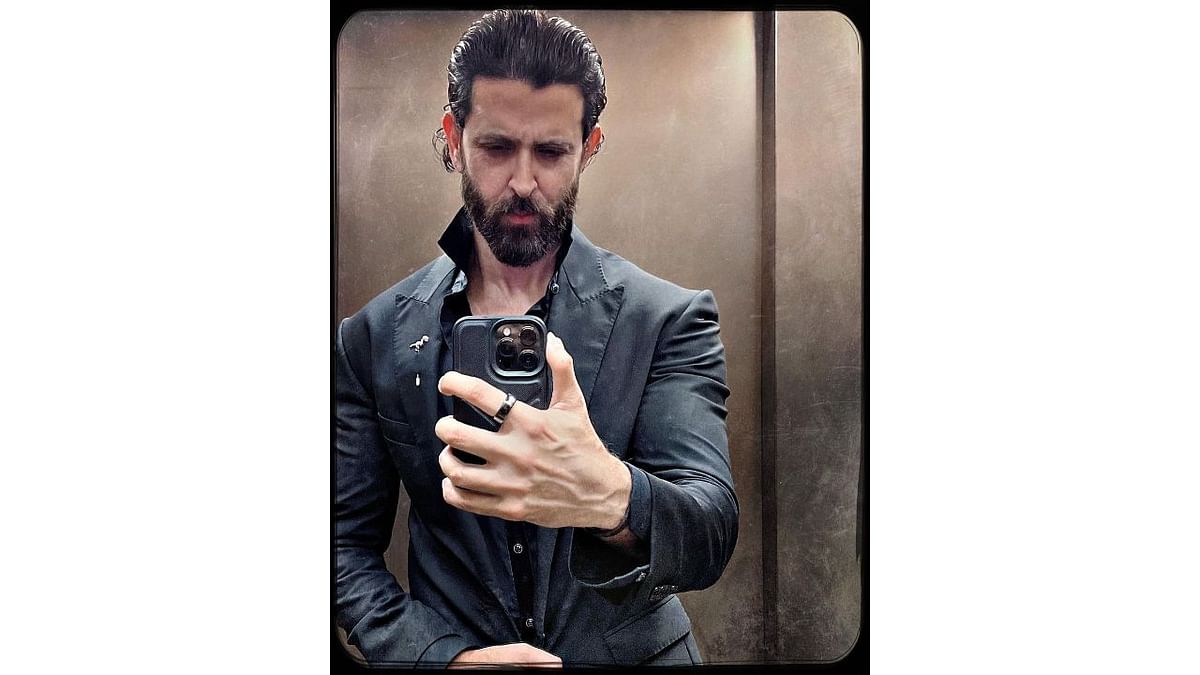 The Greek God of Bollywood, Hrithik Roshan looked dapper in a black suit. Credit: Instagram/hrithikroshan
