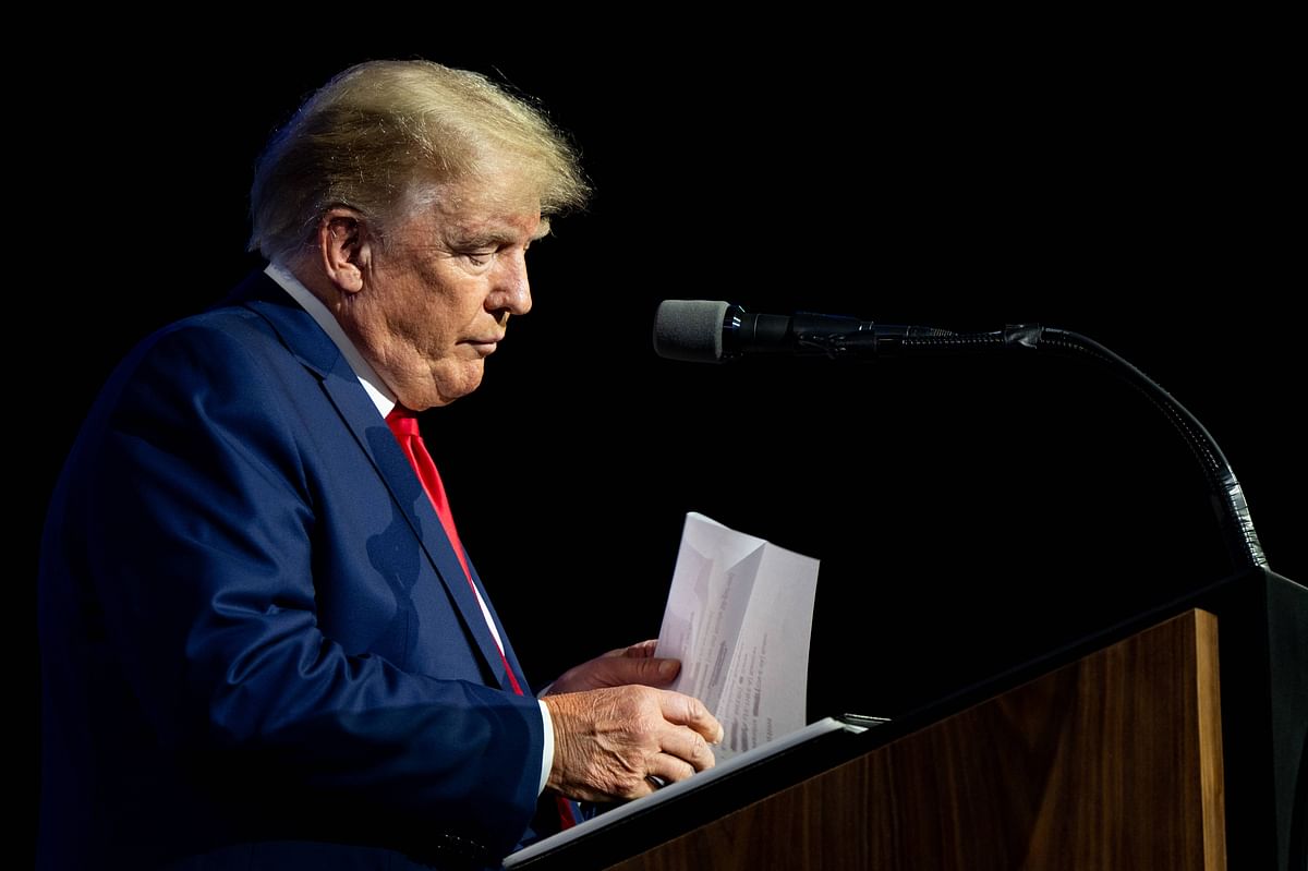 Former U.S. President Donald Trump prepares to read the names of the victims of the Uvalde mass shooting during the National Rifle Association (NRA) annual convention. Credit: AFP
