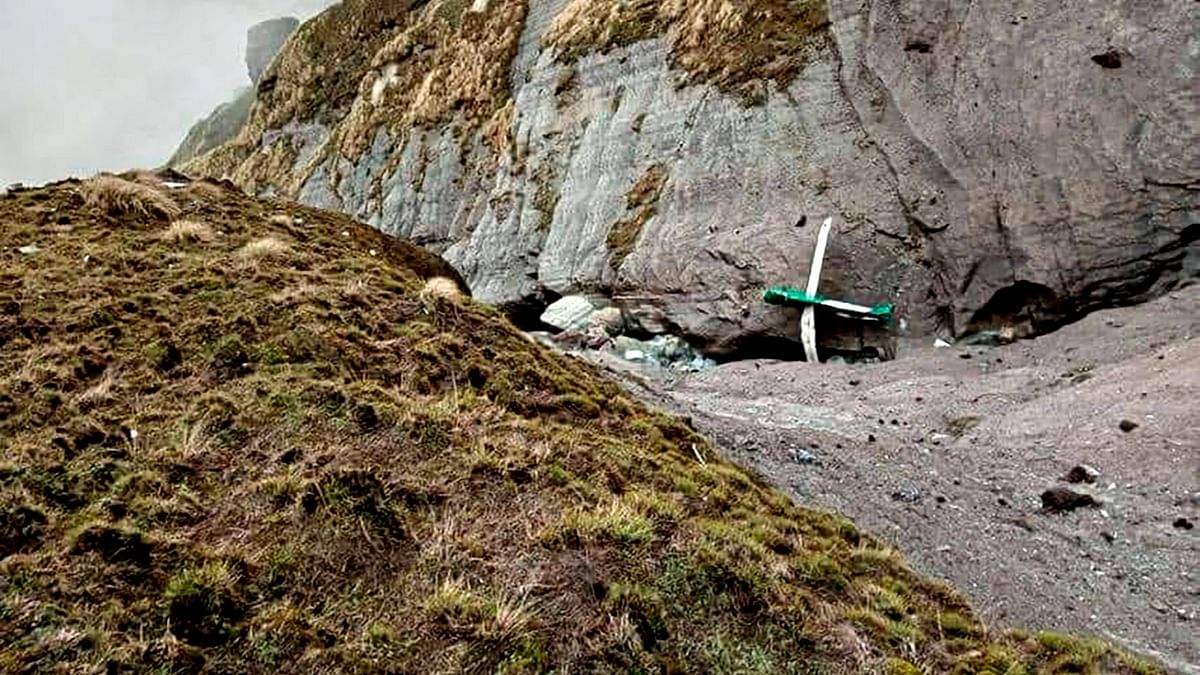 The Nepal army shared a photo of aircraft parts and other debris littering a sheer mountainside, including a wing with the registration number 9N-AET clearly visible. Credit: AFP Photo