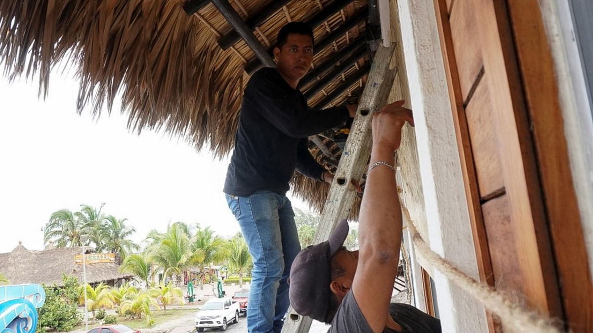 Men board up windows as they prepare for the arrival of Hurricane Agatha, in Puerto Escondido, Oaxaca state, Mexico. Credit: Reuters photo