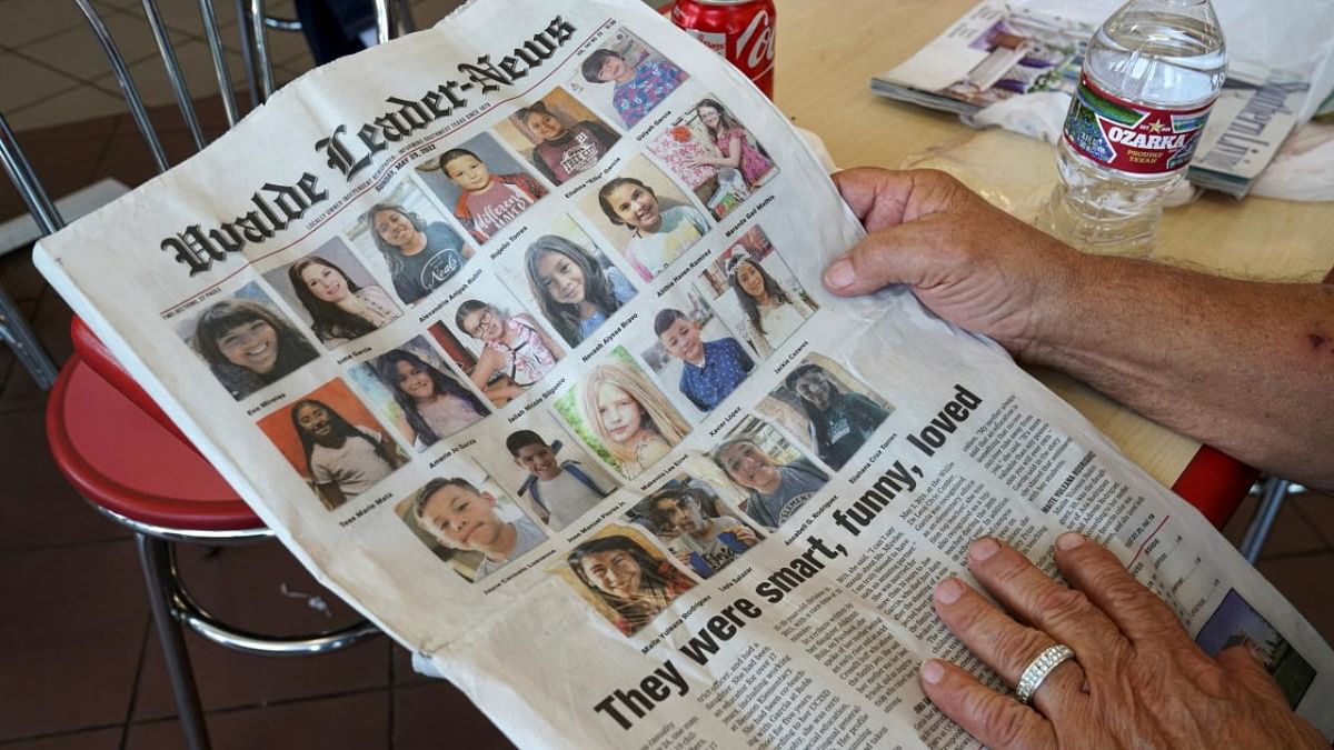 Cesar Hernandez, 80, shows the newspaper with photos of the victims of the deadliest U.S. school shooting in nearly a decade where a gunman killed 19 children and two teachers at Robb Elementary school, in Uvalde, Texas. Credit: Reuters photo