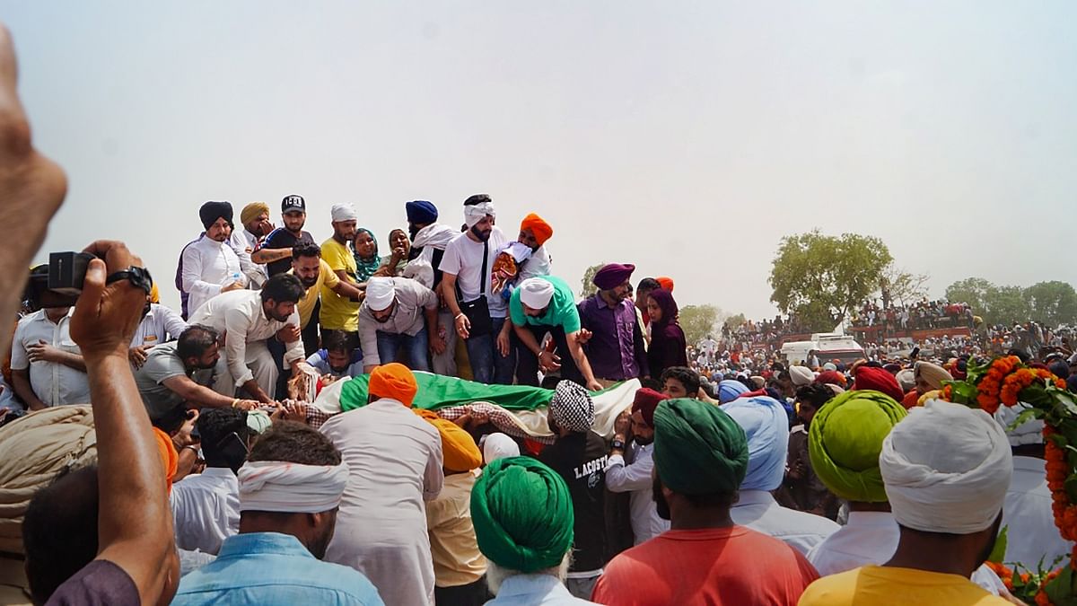 Supporters and fans of Shubhdeep Singh aka Sidhu Moosewala join the funeral procession, in Mansa, Punjab. Credit: PTI Photo