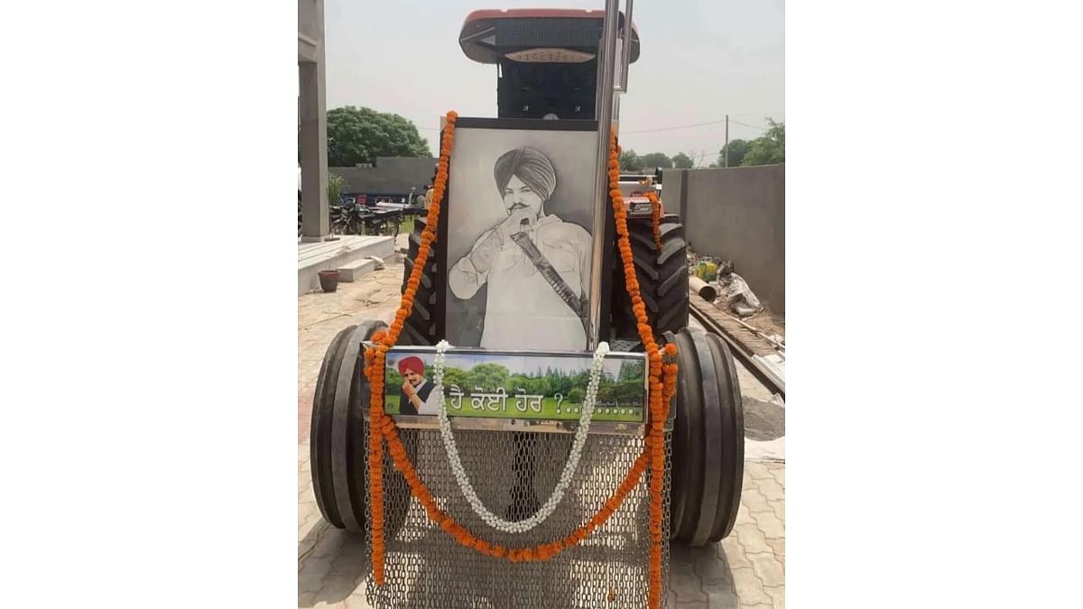 The singer's favourite tractor, which had figured in many of his music videos, was bedecked with flowers for his last ride to a family-owned field for the cremation. Credit: Special Arrangement