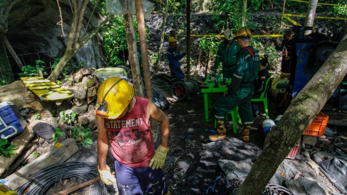 Miners waits outside the coal mine as rescuers work to save 14 miners who are still trapped underground in the Colombian municipality of Zulia, Norte de Santander Department, on the border with Venezuela. Credit: AFP Photo