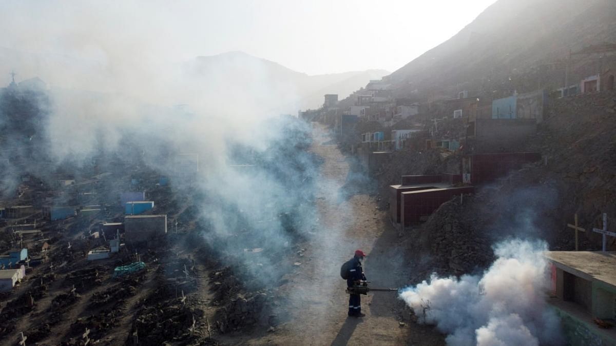 A health worker sprays fumigation vapour to stem the spread of dengue virus at the Nueva Esperanza cemetery in Lima, Peru. Credit: Reuters photo