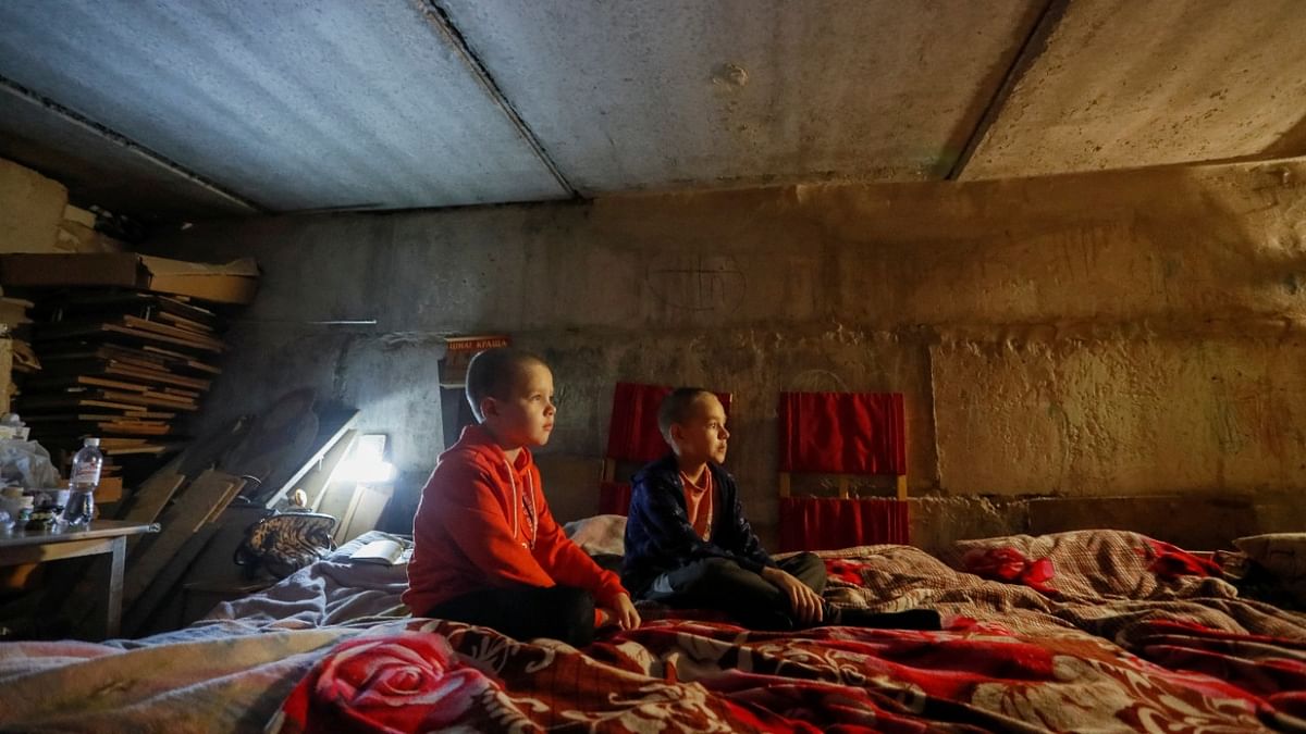 Children sit in a bomb shelter in the course of Ukraine-Russia conflict in the town of Rubizhne in the Luhansk region. Credit: Reuters photo