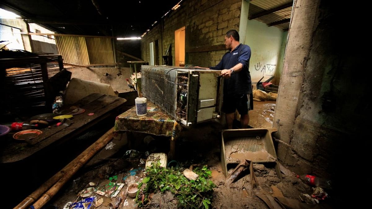 A man arranges his belongings inside his mud-covered house in the aftermath of Hurricane Agatha, in Barra Copalita, Oaxaca state, Mexico. Credit: Reuters photo