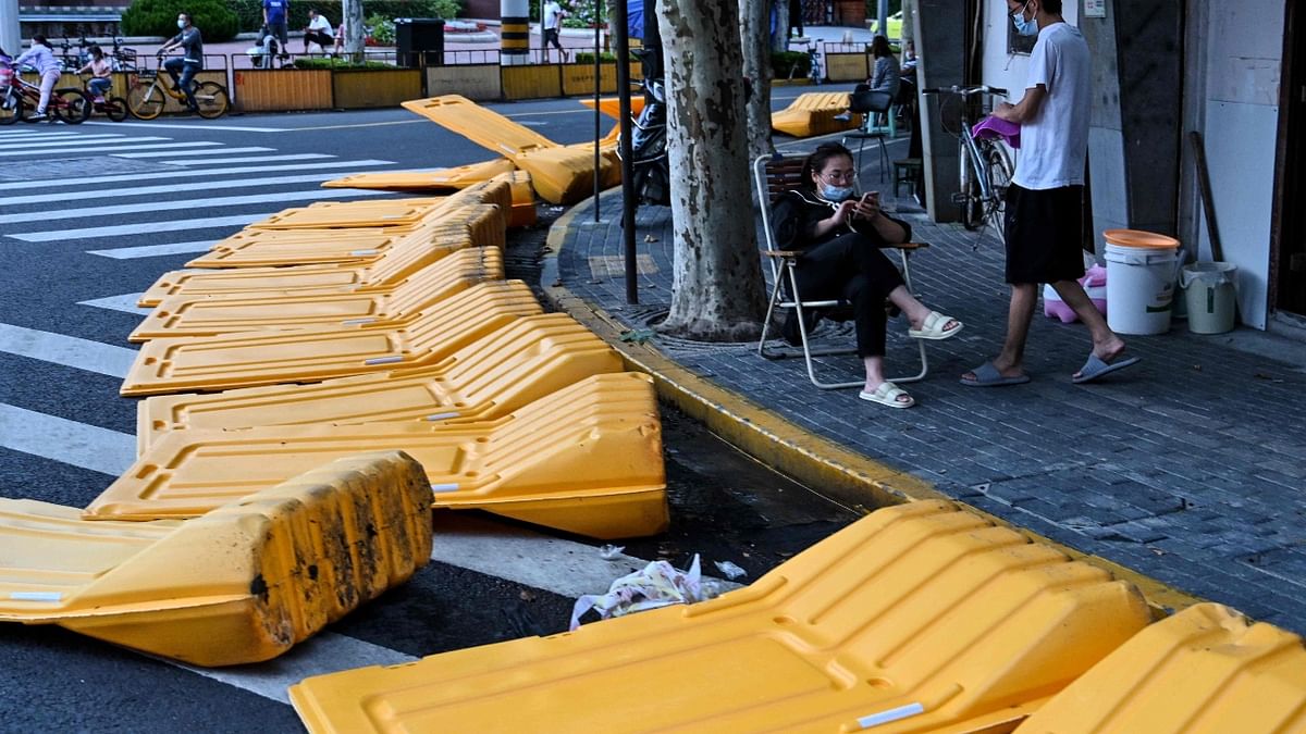 Local media showed photos of orange-clad workers dismantling some of the barriers that had been penned in districts across the city for weeks. Credit: AFP Photo