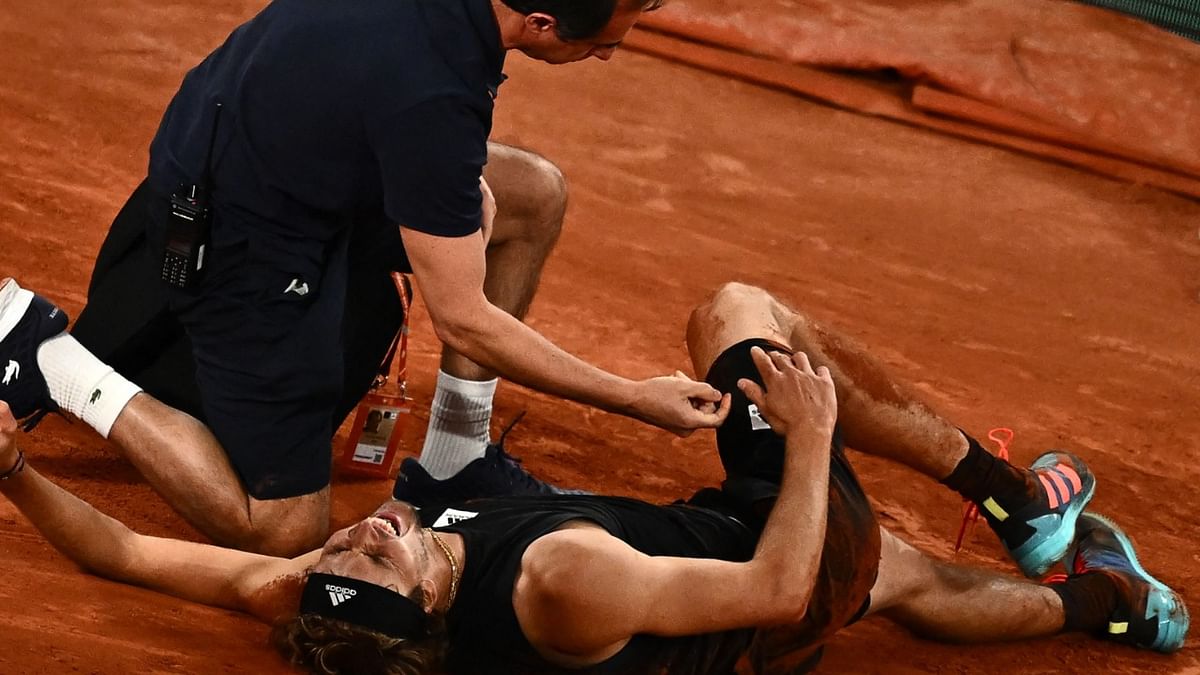 Germany's Alexander Zverev (FRONT) is assisted after being injured during his men's semi-final singles match against Spain's Rafael Nadal on day thirteen of the Roland-Garros Open tennis tournament at the Court Philippe-Chatrier in Paris. Credit: AFP Photo