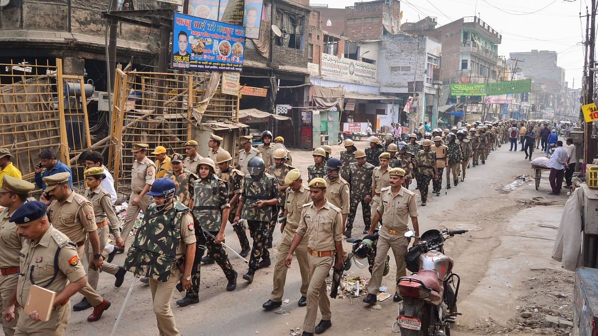 Police conducted a flag march in the locality, a day after clashes broke out between two groups over the market shut down in Kanpur. Credit: PTI Photo