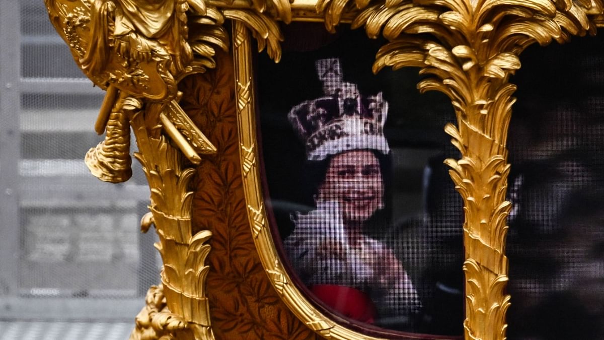 An hologram of Britain's Queen Elizabeth II is projected on the Gold State Coach during the Platinum Pageant in London. Credit: AFP Photo