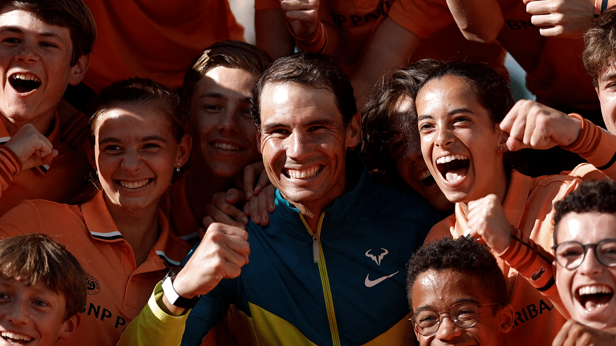Spain's Rafael Nadal poses with ballboys as he celebrates after victory over Norway's Casper Ruud during their men's singles final match on day fifteen of the Roland-Garros Open tennis tournament at the Court Philippe-Chatrier in Paris. Credit: Reuters Photo