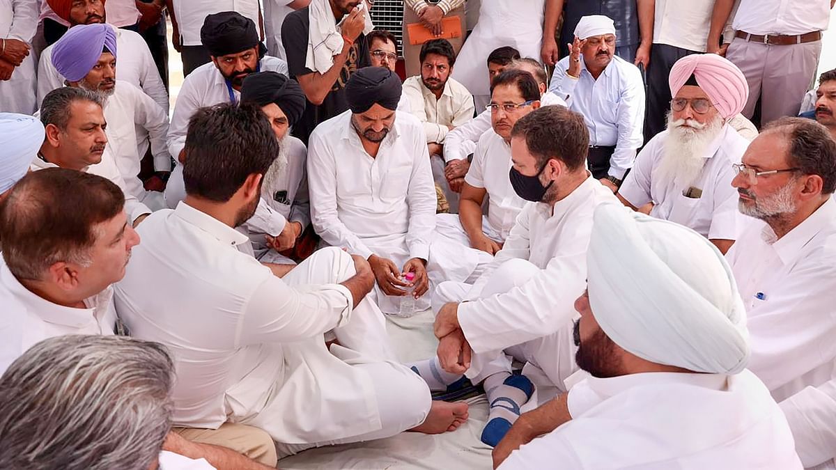 Congress leader Rahul Gandhi is seen interacting with the grieving family of late singer and Congress leader Sidhu Moosewala in Mansa. Credit: PTI Photo