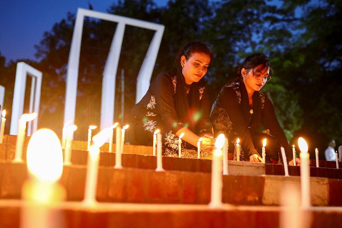 Members of Sommilito Sangskritik Jote organisation participate in a candlelight vigil in remembrance of the victims of the fire that broke out in an inland container depot in Sitakunda, in Dhaka, Bangladesh. Credit: Reuters Photo