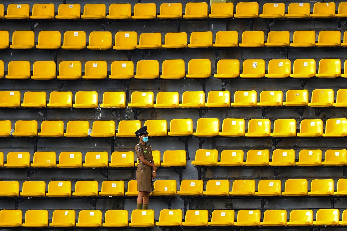 A policewoman guards the spectators' stand before the start of the first Twenty20 international cricket match between Sri Lanka and Australia at the R. Premadasa International Cricket Stadium in Colombo. Credit: AFP Photo
