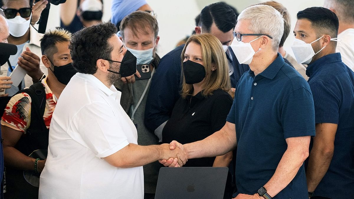 Apple CEO Tim Cook shakes the hand of French actor Mouloud Achour inside the Steve Jobs Theater during the Apple Worldwide Developers Conference (WWDC) at the Apple Park campus in Cupertino, California. Credit: AFP Photo