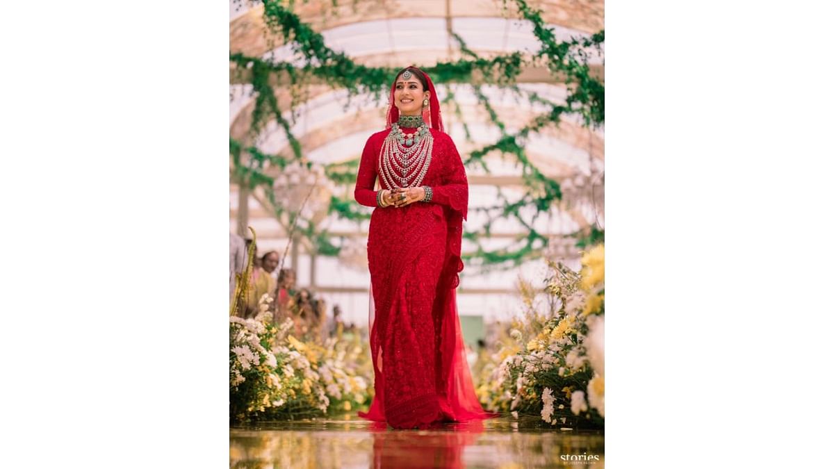 The bride Nayanthara looked radiant in a handcrafted saree in JADE’s signature Vermillion Red, custom designed by Monica Shah. Credit: Instagram/wikkiofficial