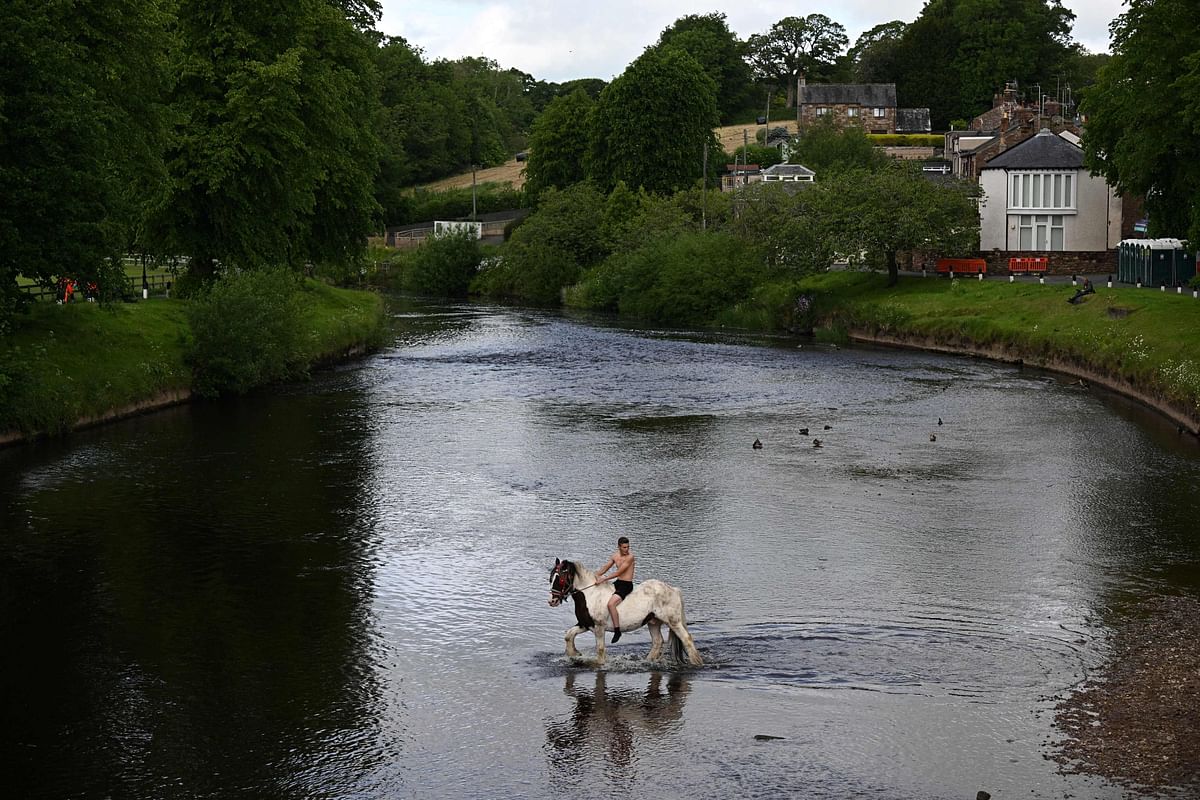 A man rides a horse in the river on the first day of the annual Appleby Horse Fair, in the town of Appleby-in-Westmorland, north west England. Credit: AFP Photo