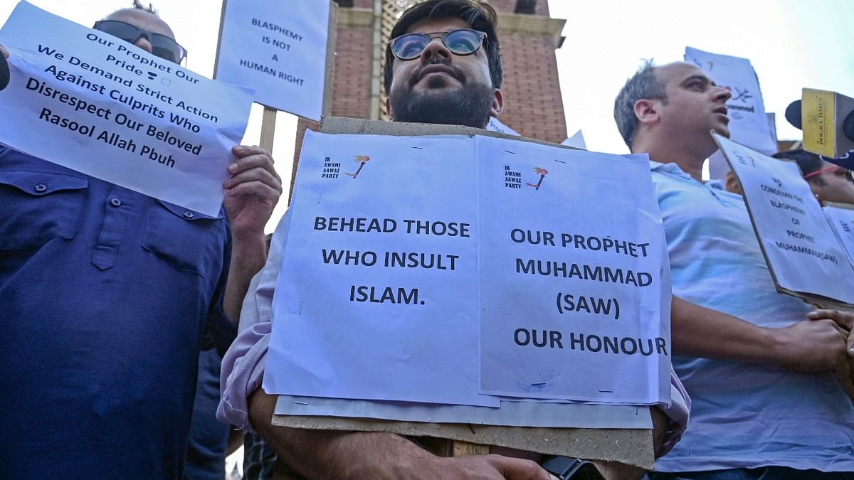At some places, protestors were seen holding placards after the Friday congregational prayers. Credit: AFP Photo