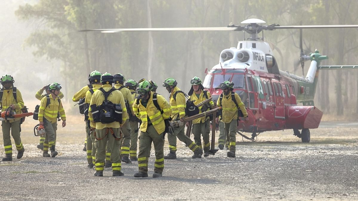 Emergency agencies have deployed close to 1,000 firefighters, military personnel and support crews to combat the massive fire. Credit: AP Photo