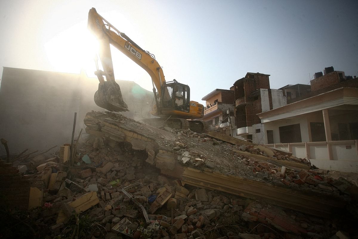 A bulldozer demolishes the house of a Muslim man that Uttar Pradesh state authorities accuse of being involved in riots last week, that erupted following comments about Prophet Mohammed by BJP. Credit: Reuters Photo