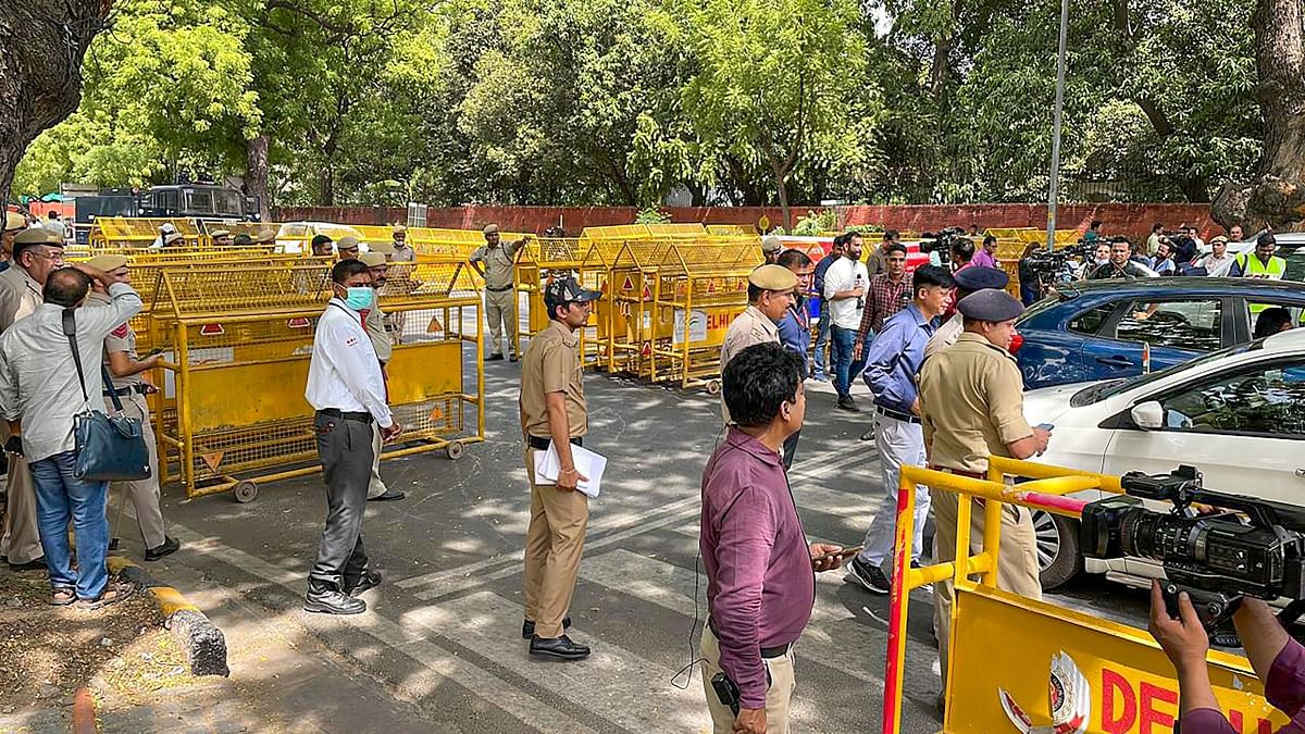 Media personnel and police present near the ED office, during the summoning of Congress leader Rahul Gandhi in the National Herald case in New Delhi. Credit: PTI Photo