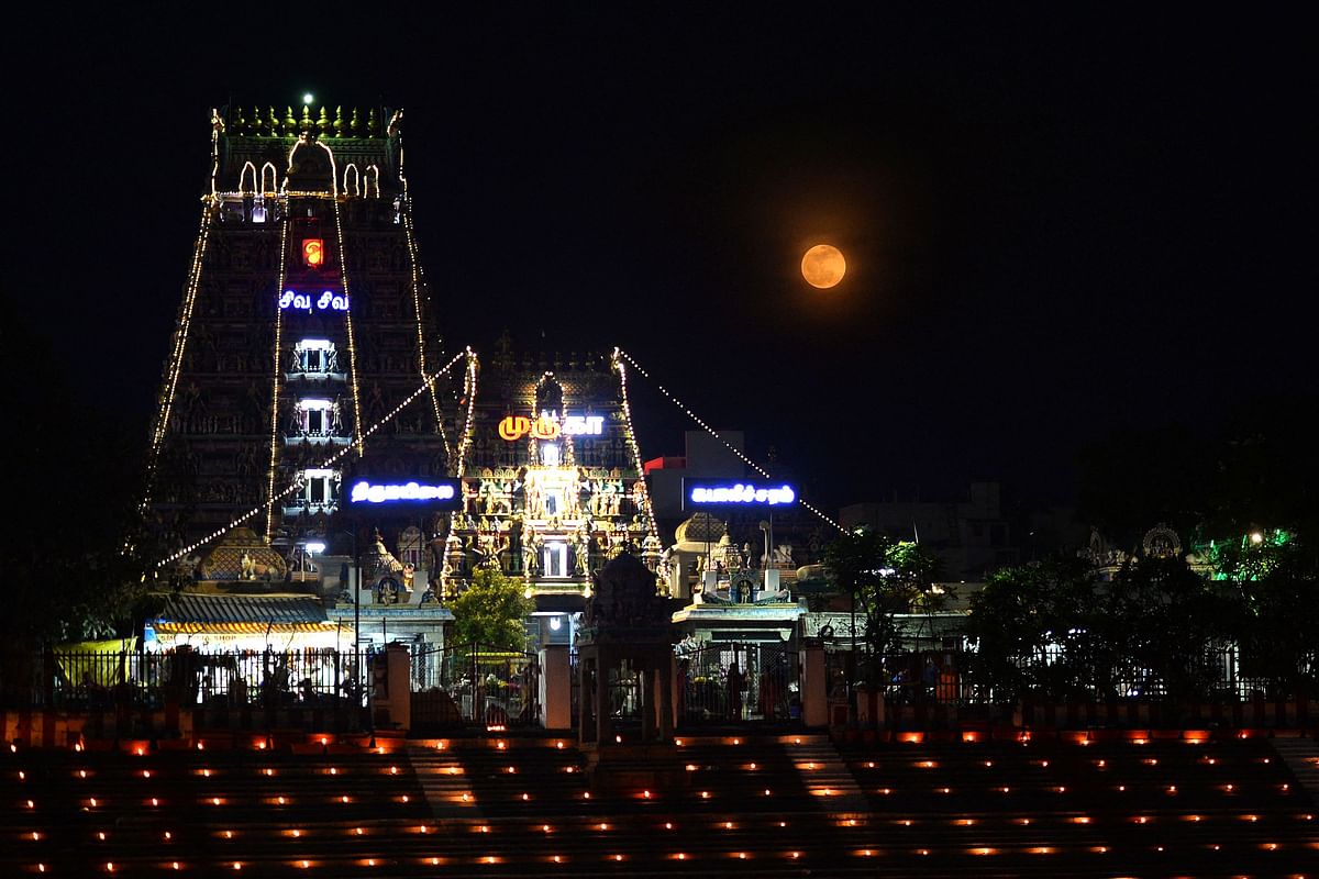 Full moon is pictured next to the illuminated Kapaleeswarar temple on occasion of Vaikasi Visagam celebration in Chennai. Credit: AFP photo