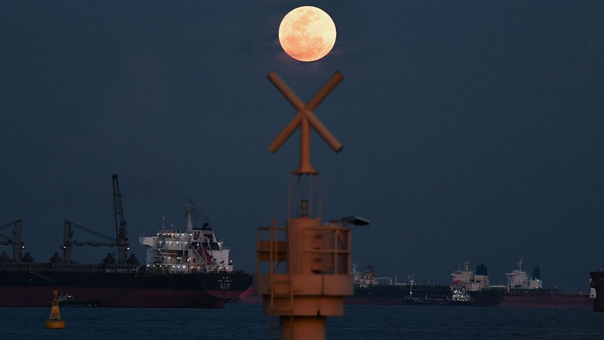 The full moon rises as the June 2022 'Strawberry Supermoon' in Singapore. Credit: AFP Photo