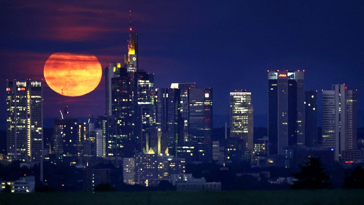The 'Strawberry Moon' is seen rising behind the skyline of Frankfurt, Germany. Credit: Reuters Photo