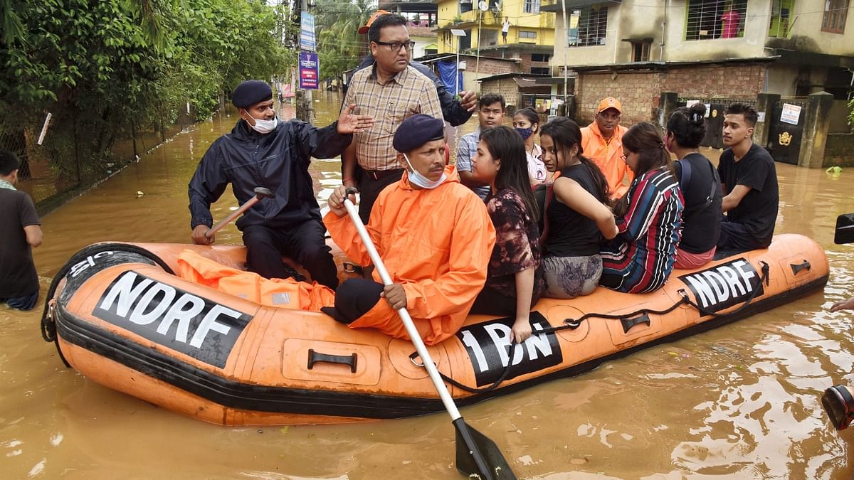 NDRF and SDRF personnel, deployed in these areas, are using boats to rescue people and offer relief materials to those still stuck in flooded homes. Credit: PTI Photo