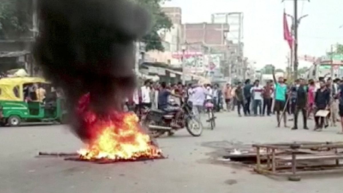 Hundreds of agitators blocked National Highway 83 in Jehanabad and burned tyres demanding the scrapping of the scheme. Angry protestors took out processions in the three districts and other parts of the state. Credit: Reuters Photo