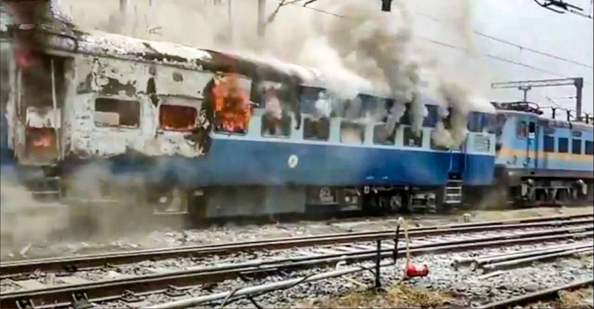 Smoke billows out after youngsters set on fire a train in protest against the 'Agnipath' scheme, at Chapra Railway Station. Credit: PTI Photo