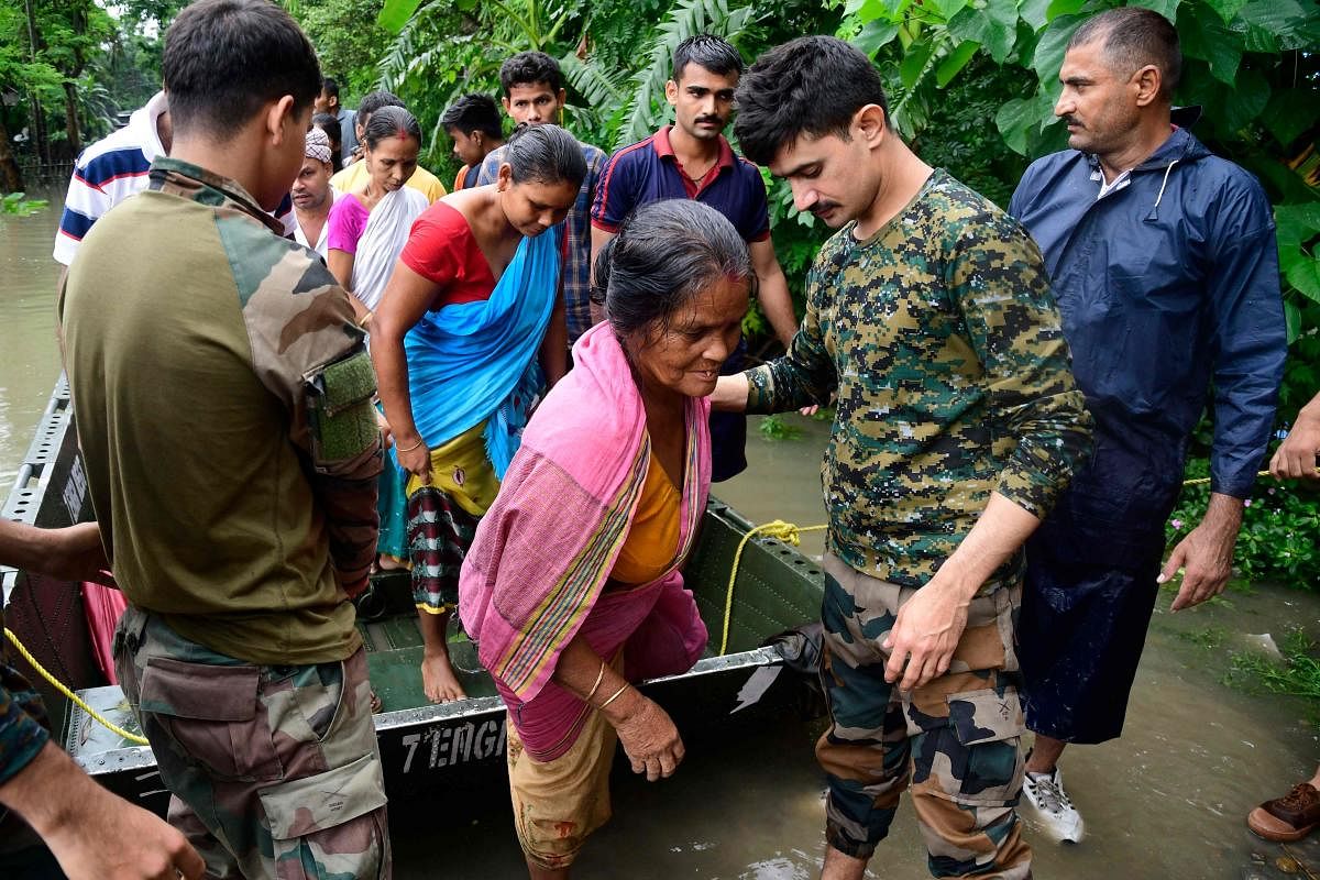 Army soldiers evacuate flood-affected villagers following heavy monsoon rainfalls in Rangia of Kamrup district, in India's Assam state. Credit: AFP Photo