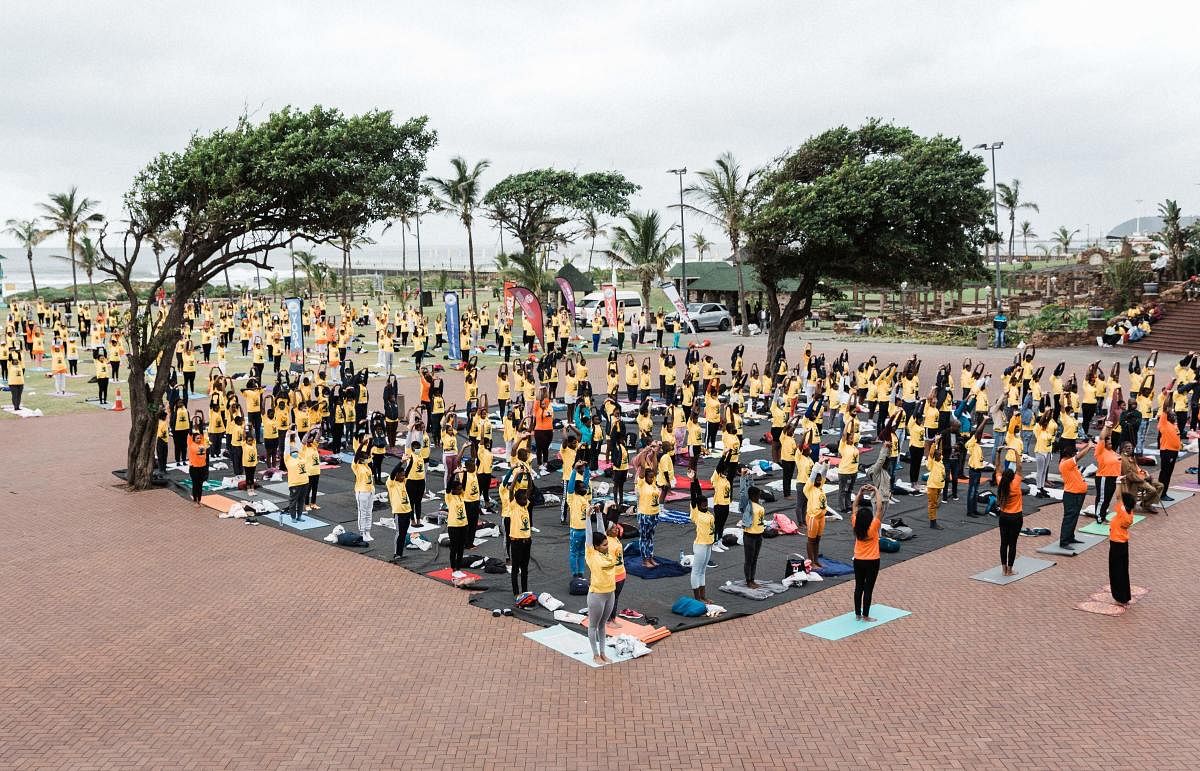 Yoga enthusiasts take part in a mass yoga session at the amphitheatre lawns at North Beach in Durban, South Africa, ahead of the International Day of Yoga on June 21. Credit: AFP Photo