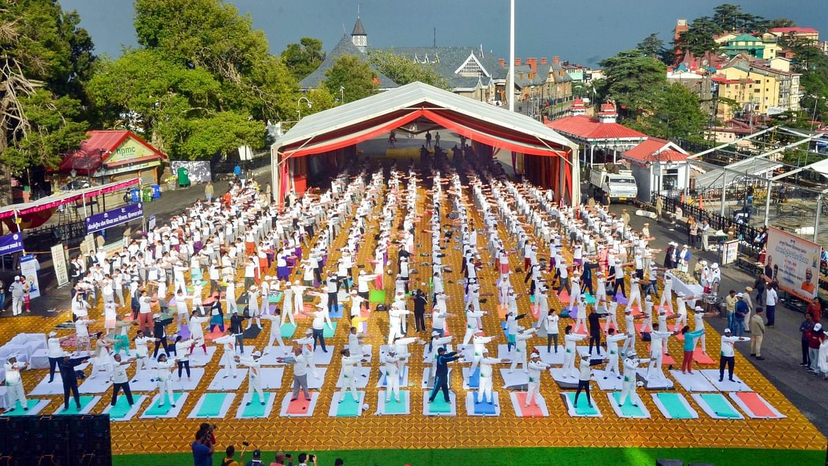 Hundreds of people participate in a yoga session on the occasion of the 8th International Day of Yoga, at Ridge, in Shimla. Credit: PTI Photo