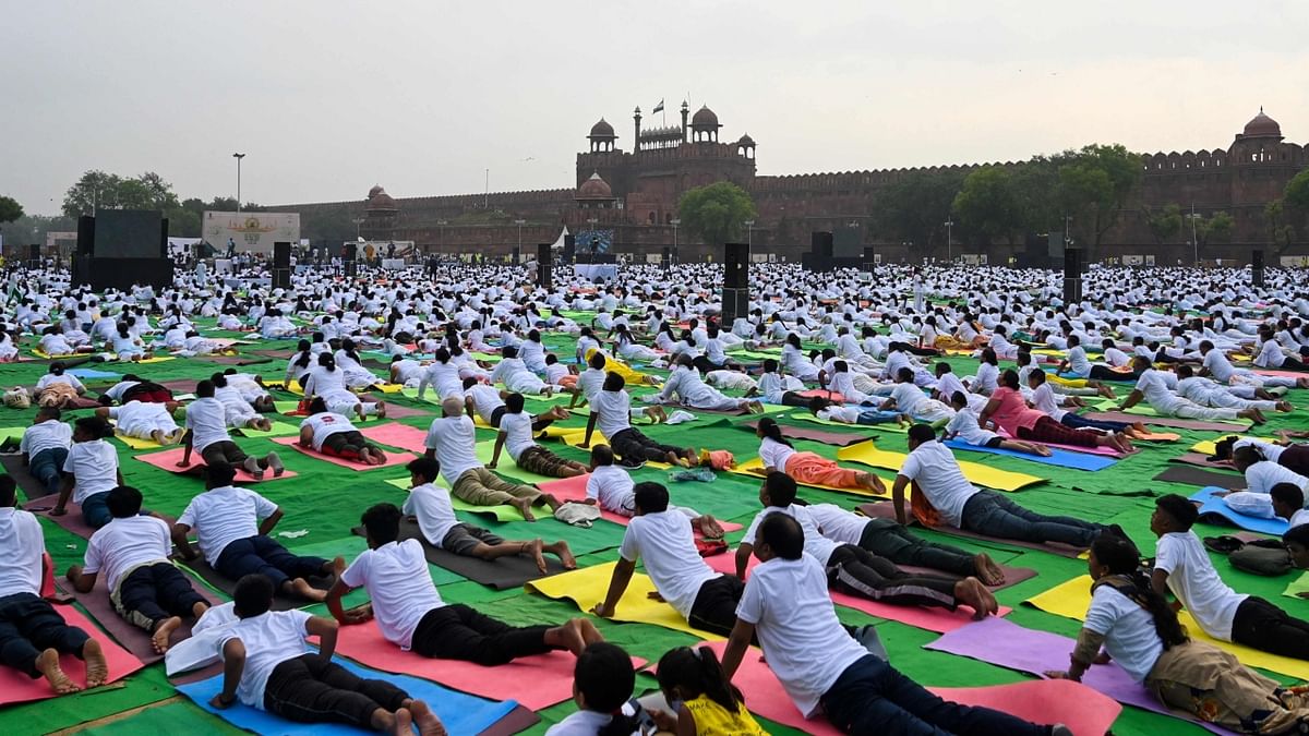 People participate in a mass yoga session to celebrate the International Day of Yoga in front of the Red Fort in New Delhi. Credit: PTI Photo