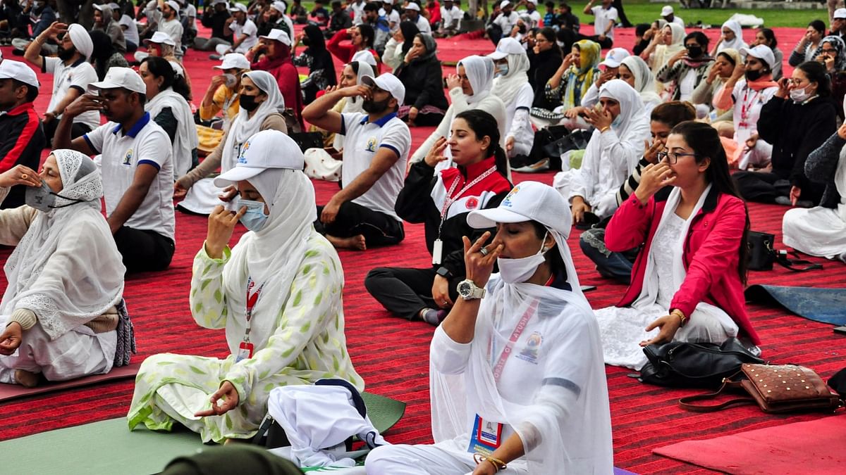 College students and locals attend a mass yoga session on the banks of the Dal Lake to celebrate the International Day of Yoga, in Srinagar. Credit: PTI Photo